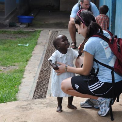 Nicole Mendoza share a momeent with a child during a community visit