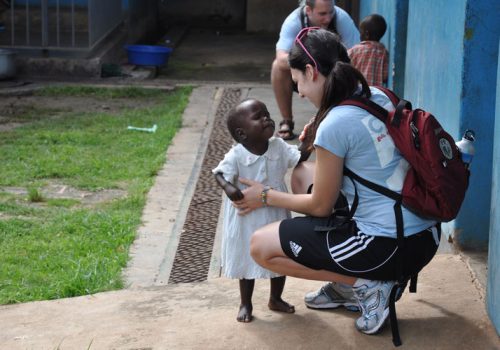 Nicole Mendoza share a momeent with a child during a community visit